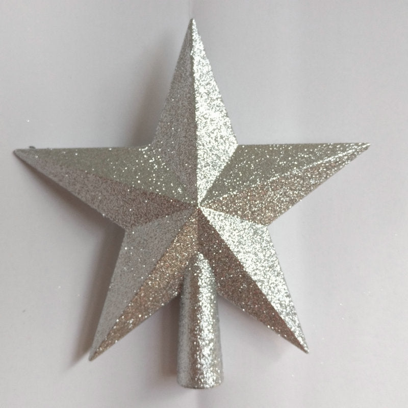 Glittery star-shaped object on a light gray background