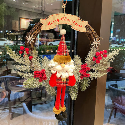 Decorative Christmas wreath with a Santa Claus figure and 'Merry Christmas' banner in a cafe setting.