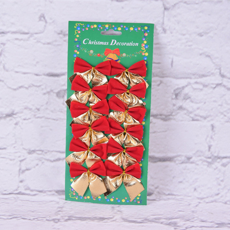 Packaged Christmas decorations with red and gold bows on a textured white background