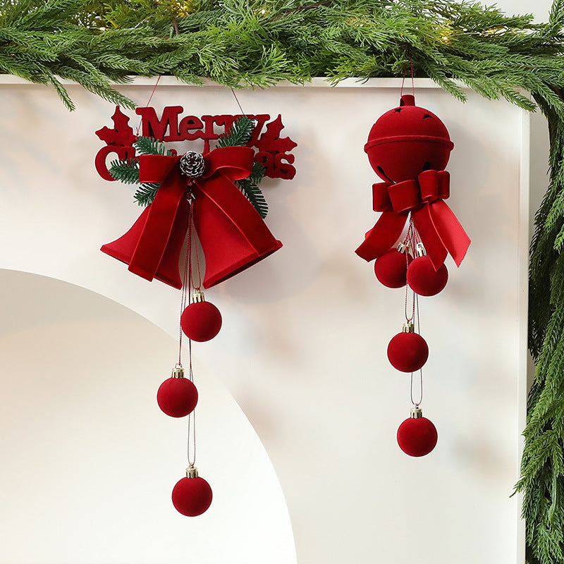 Red Christmas ornaments with ribbons and balls hanging on a white background.