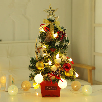 Decorative Christmas tree with lights and ornaments on a table.