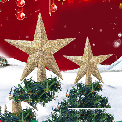 Two gold glittery star tree toppers on Christmas trees with a red background