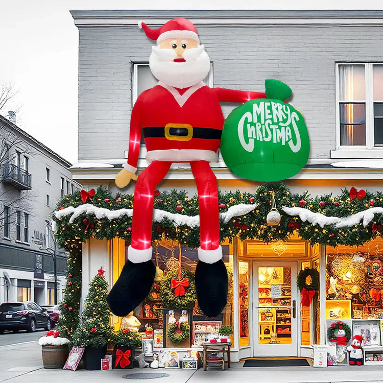 Inflatable Santa Claus decoration holding a 'Merry Christmas' sign in front of a store with holiday decorations.