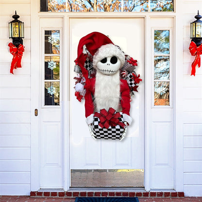 Decorative door hanger with a skeleton in a Santa outfit on a white door.