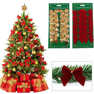 Decorated Christmas tree with red and gold bows, presents, and two packages of additional bows.