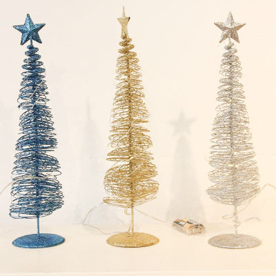 Three decorative Christmas trees in blue, gold, and silver with star toppers on a light background.