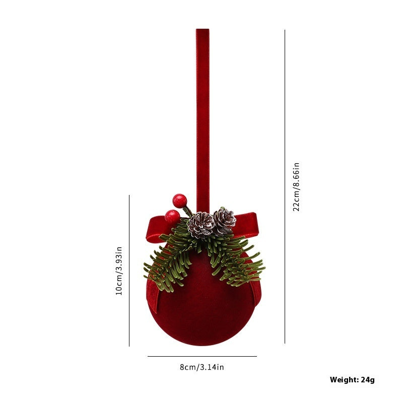 Red Christmas ornament with greenery and measurements on a white background