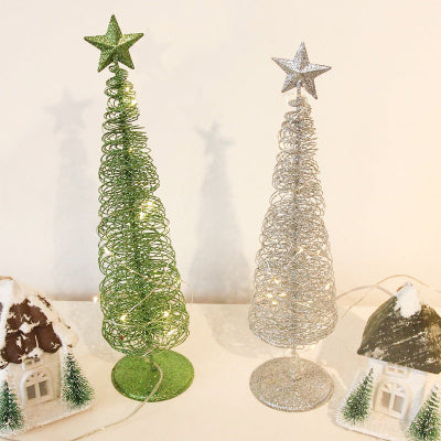 Two decorative Christmas trees with star toppers on a neutral background